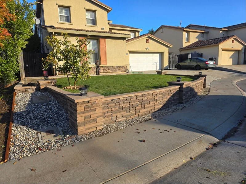 Front yard after new sod and stone retaining wall installed with sprinkler irrigation in Sacramento CA